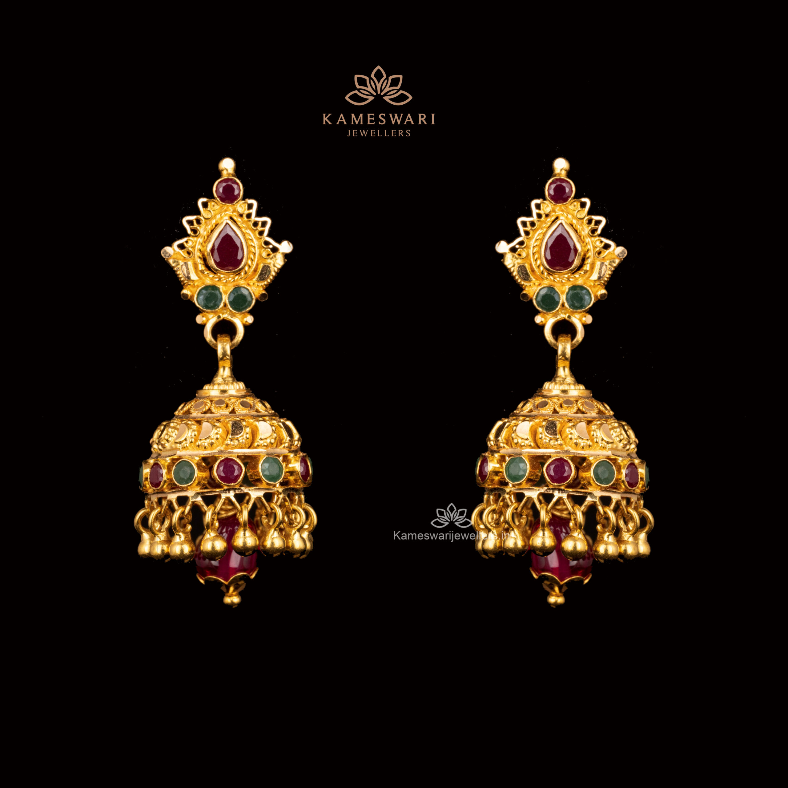Gold Jhumkas with ruby, emerald accents, and intricate filigree. Gold Jhumkas with ruby, emerald accents, and intricate filigree.
