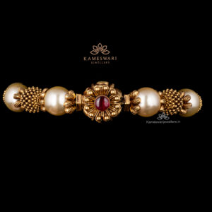 Antique Bangle with intricate floral pattern and pearls.